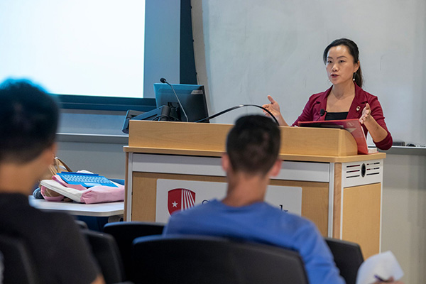 Professor at lectern in front of class