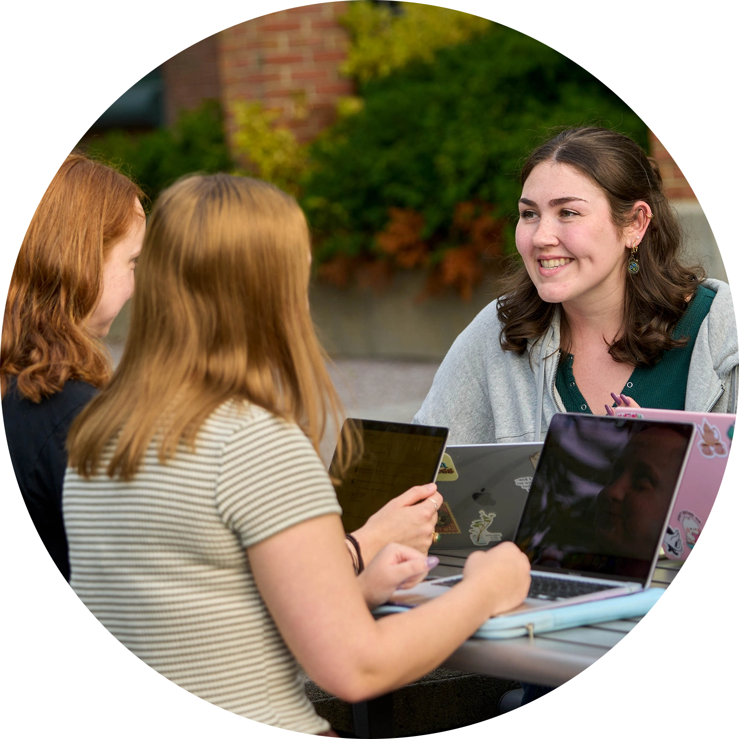 Two College of Business Students focusing on their classwork while attending a lecture