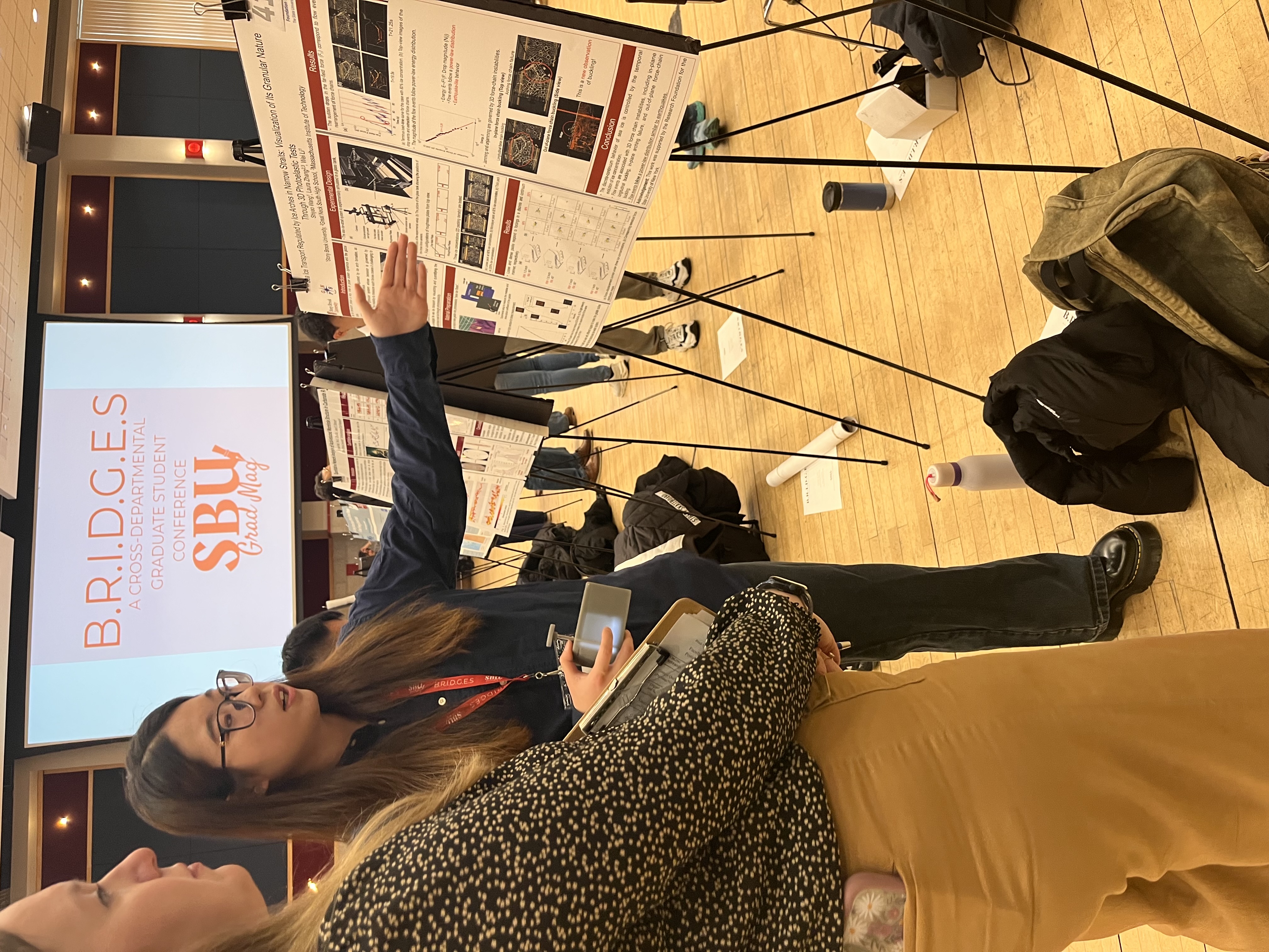 S. Wang presenting poster to faculty